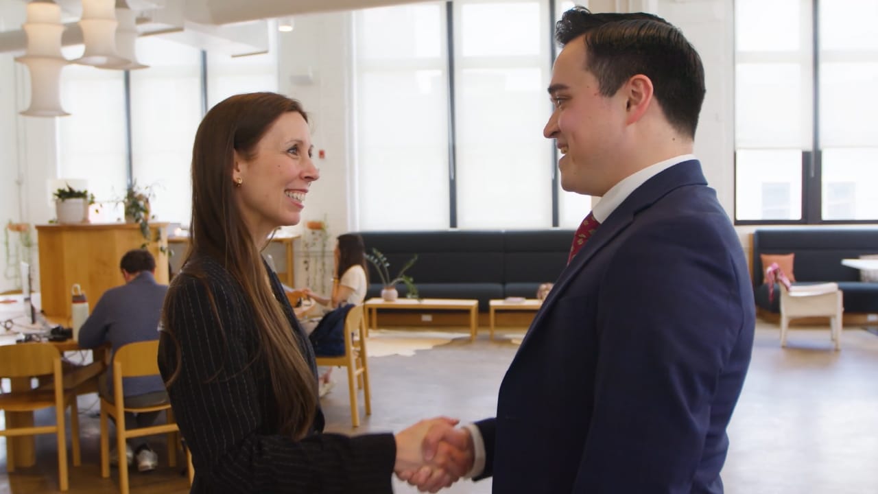 people shaking hands and smiling